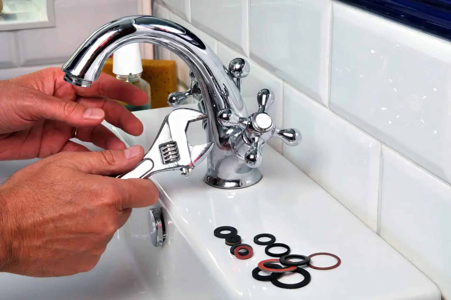 Plumber maintaining a bathroom faucet in Belmont