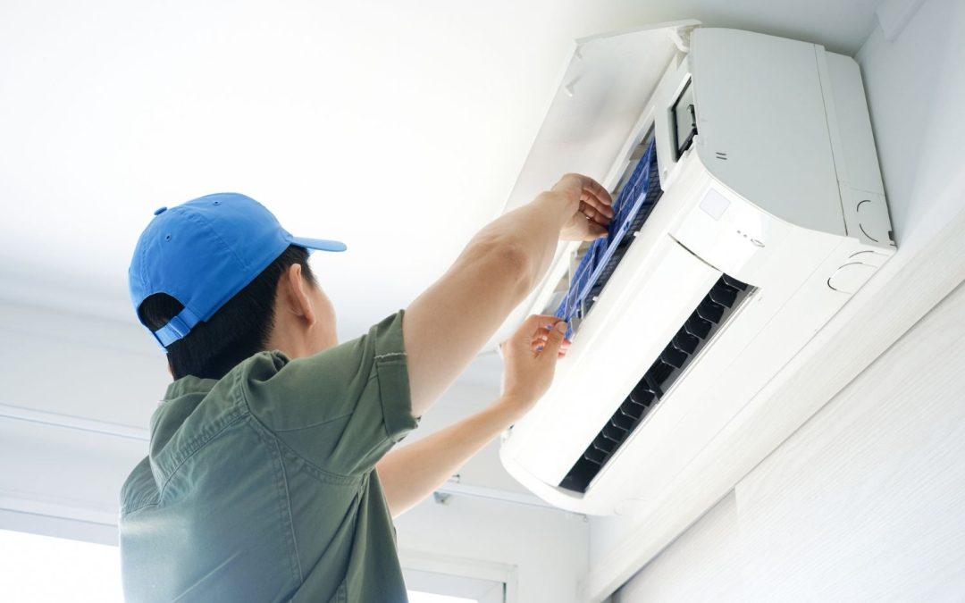 HVAC technician servicing a ductless mini split in Belmont