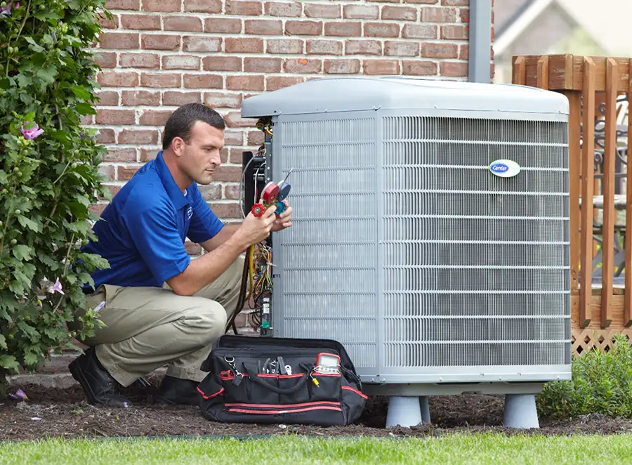 HVAC technician inspecting an outdoor AC unit in Belmont